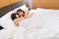 Girls embracing in bed